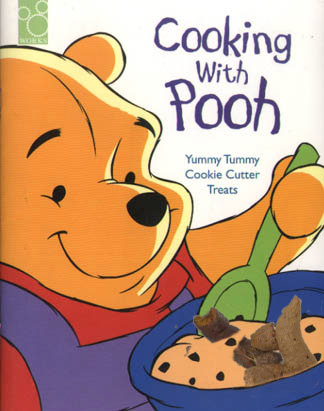 Book cover: Cooking With Pooh. Pooh happily stirs up dough, currants and some dog shit in a bowl.