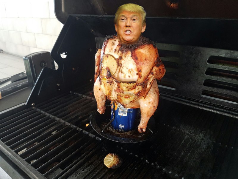 Barbecued chicken with a beer can up its arse and the face of Donald Trump